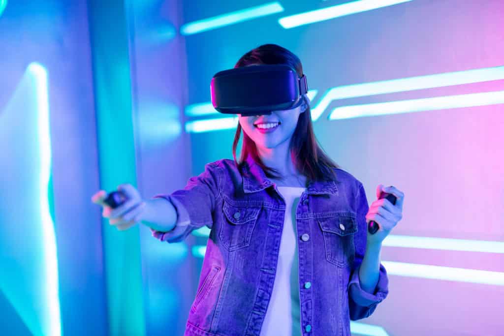 A lady wearing VR glasses and enjoying the virtual reality